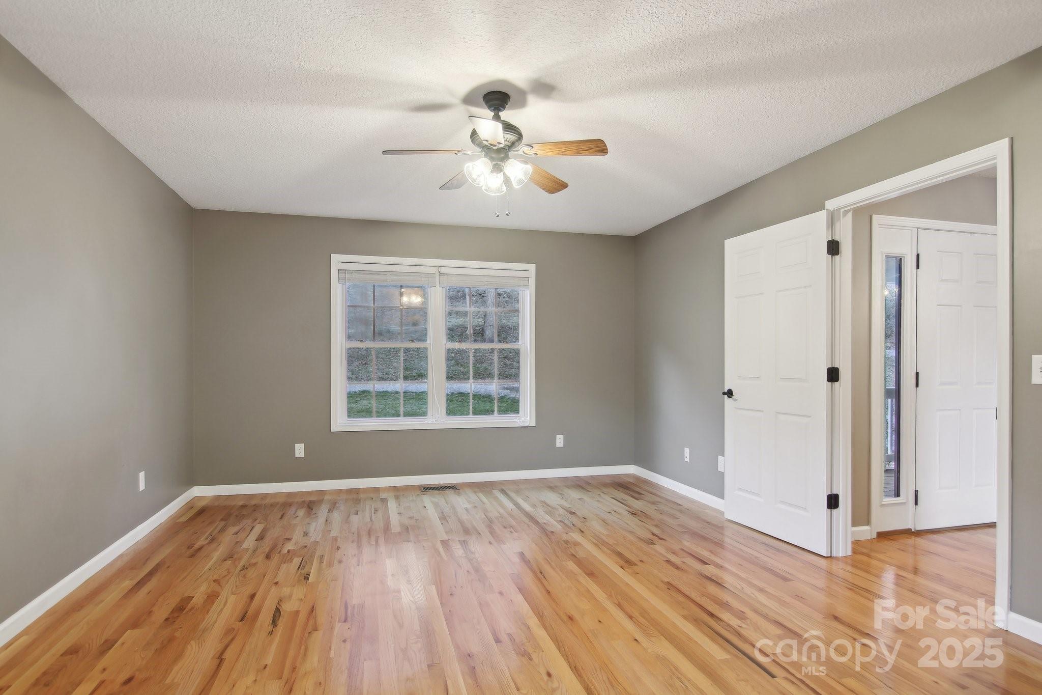 76 Eastern Sky Drive Canton, NC 28716 - Photo 26 of 48 a view of an empty room with wooden floor and a window