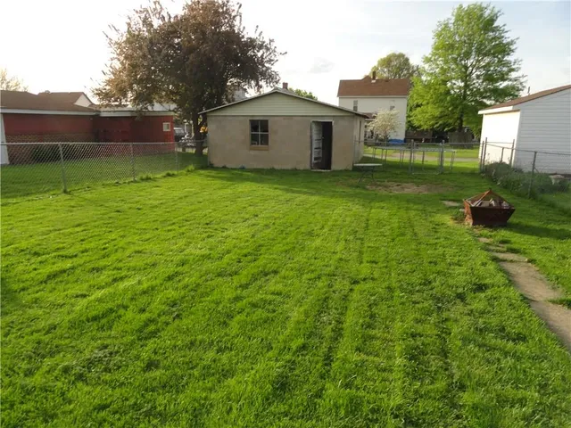 a view of a small house with a yard