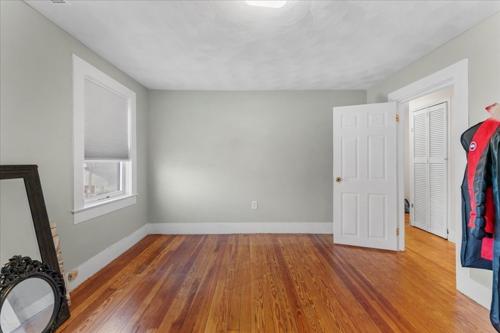 49 A Massasoit Avenue, Unit 2 Hull, MA 02045 - Photo 11 of 19 an empty room with wooden floor and a window