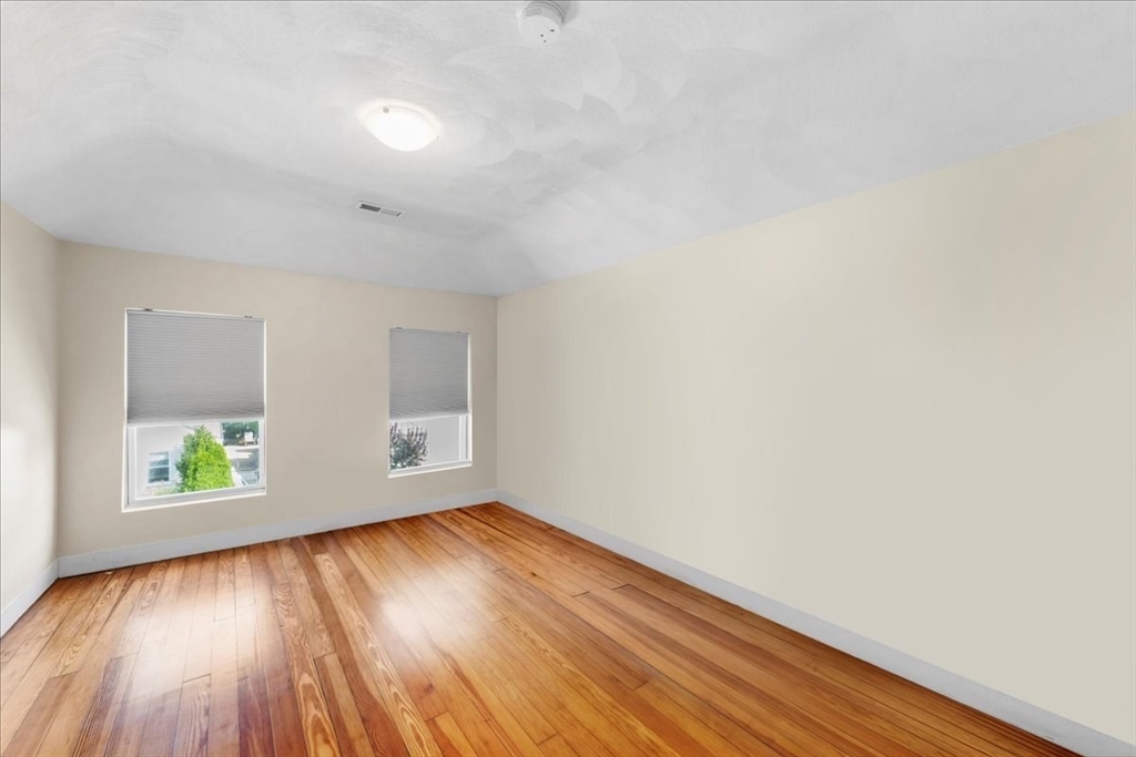 49 A Massasoit Avenue, Unit 2 Hull, MA 02045 - Photo 14 of 19 an empty room with wooden floor and windows