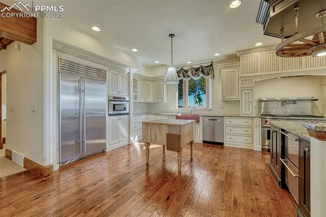 a kitchen with a sink stainless steel appliances and cabinets