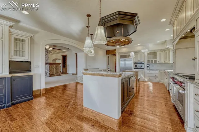a kitchen with stainless steel appliances granite countertop a stove and a sink