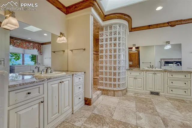 a bathroom with a sink a toilet a mirror and shower