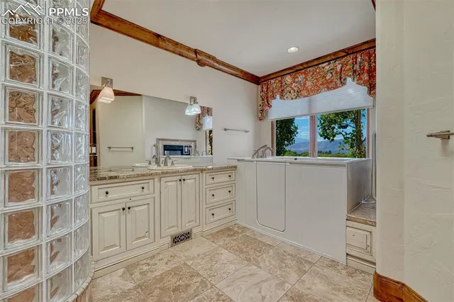 a spacious bathroom with a double vanity sink and a mirror
