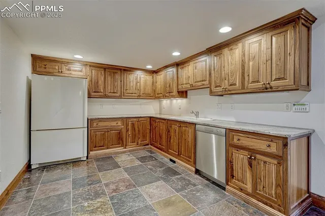 a kitchen with a refrigerator sink and cabinets