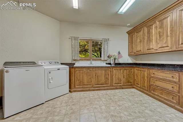 a view of cabinets a sink and a stove in a kitchen
