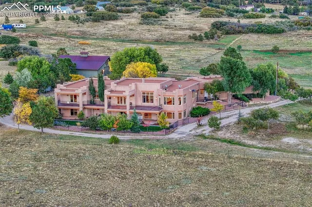 an aerial view of house with yard and lake view