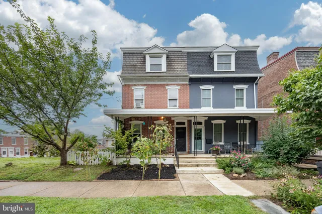 a front view of a house with garden and porch
