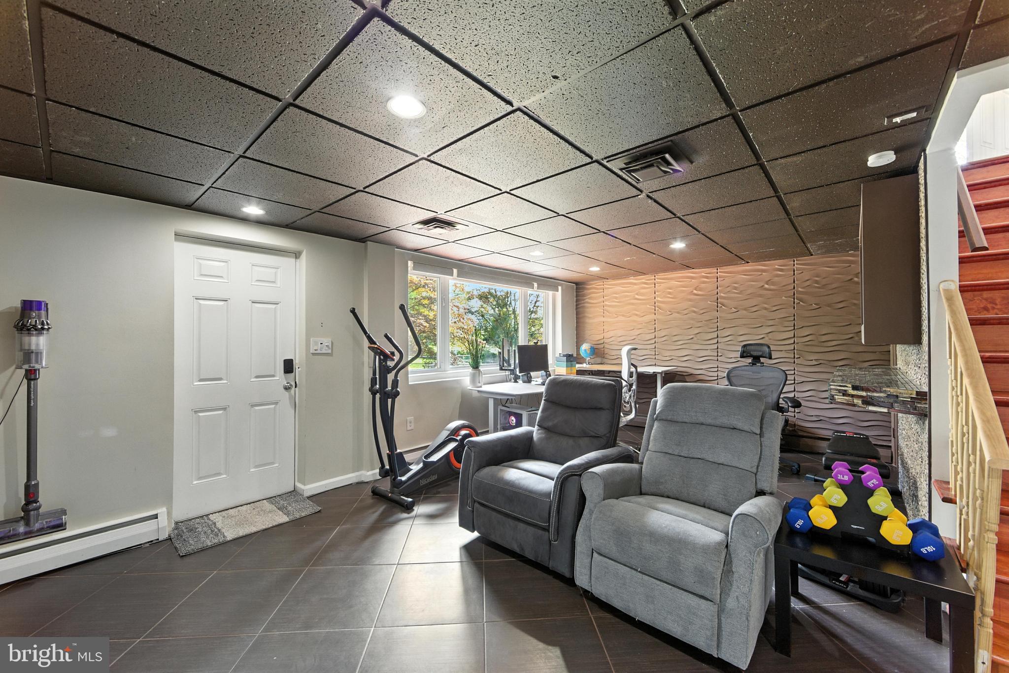 336 Kent Road Springfield, PA 19064 - Photo 15 of 36 a living room with furniture and a gym machine