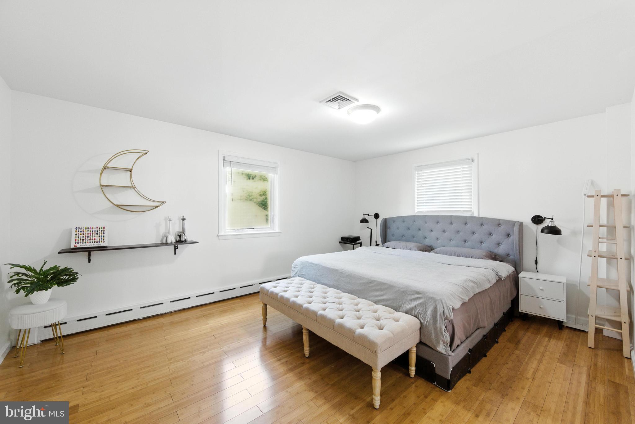 336 Kent Road Springfield, PA 19064 - Photo 32 of 36 a bedroom with a bed chandelier and a window