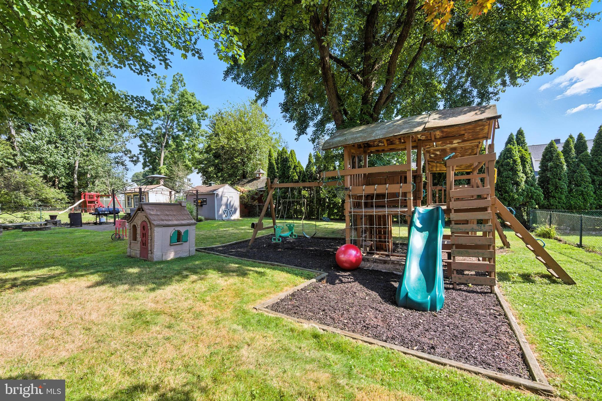 336 Kent Road Springfield, PA 19064 - Photo 8 of 36 a view of a backyard with potted plants and a large tree