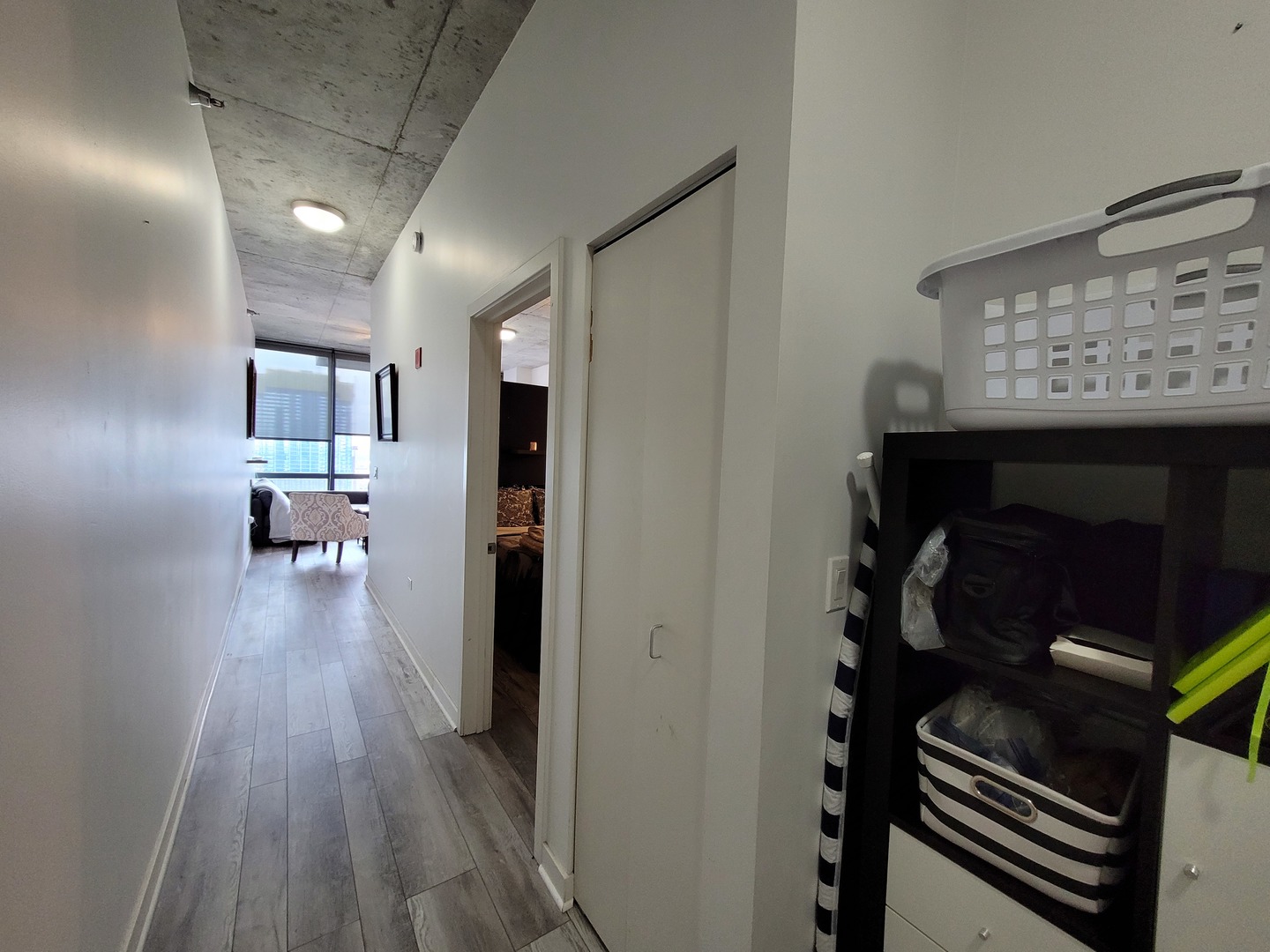 235 West Van Buren Street, Unit 2608 Chicago, IL 60607 - Photo 14 of 20 a hallway with wooden floor electronic appliances and stairs
