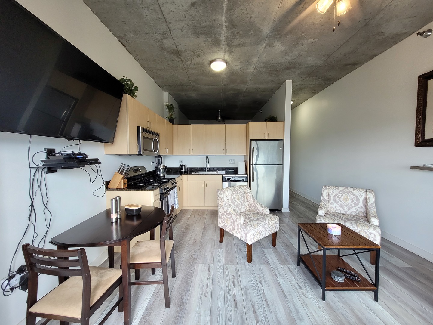 235 West Van Buren Street, Unit 2608 Chicago, IL 60607 - Photo 6 of 20 a living room with lots of furniture and kitchen view