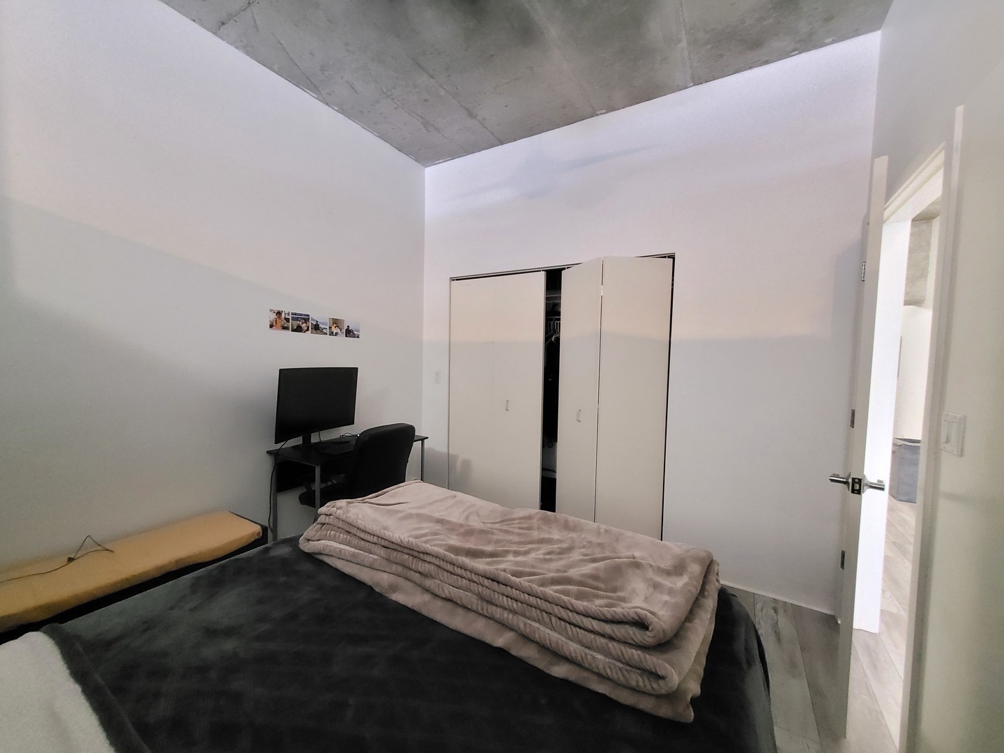 235 West Van Buren Street, Unit 2608 Chicago, IL 60607 - Photo 9 of 20 a bedroom with a bed and a table in it
