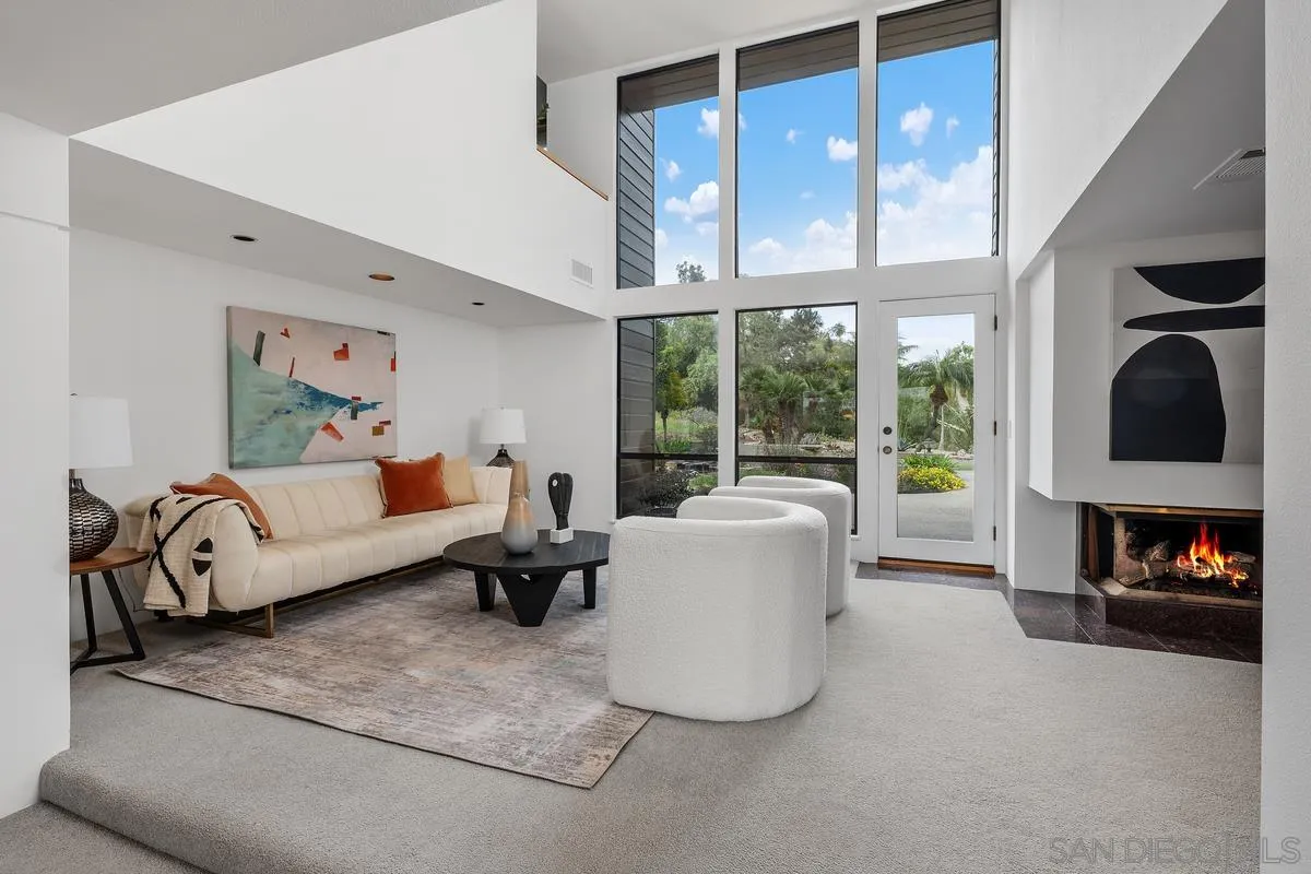 14430 Rancho Santa Fe Farms Road Rancho Santa Fe, CA 92067 - Photo 16 of 51 a living room with furniture a fireplace and floor to ceiling window