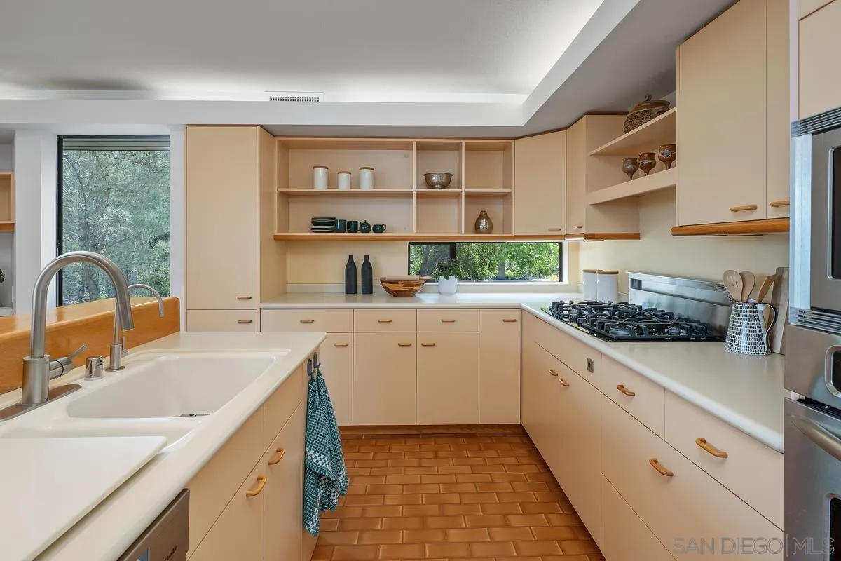 14430 Rancho Santa Fe Farms Road Rancho Santa Fe, CA 92067 - Photo 24 of 51 a kitchen with a sink stove top oven and cabinets