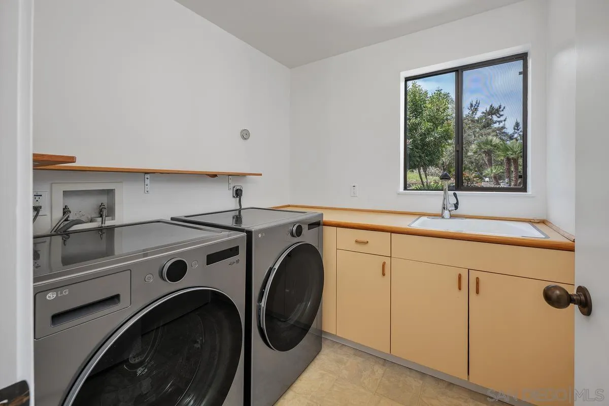 14430 Rancho Santa Fe Farms Road Rancho Santa Fe, CA 92067 - Photo 25 of 51 a utility room with sink dryer and washer