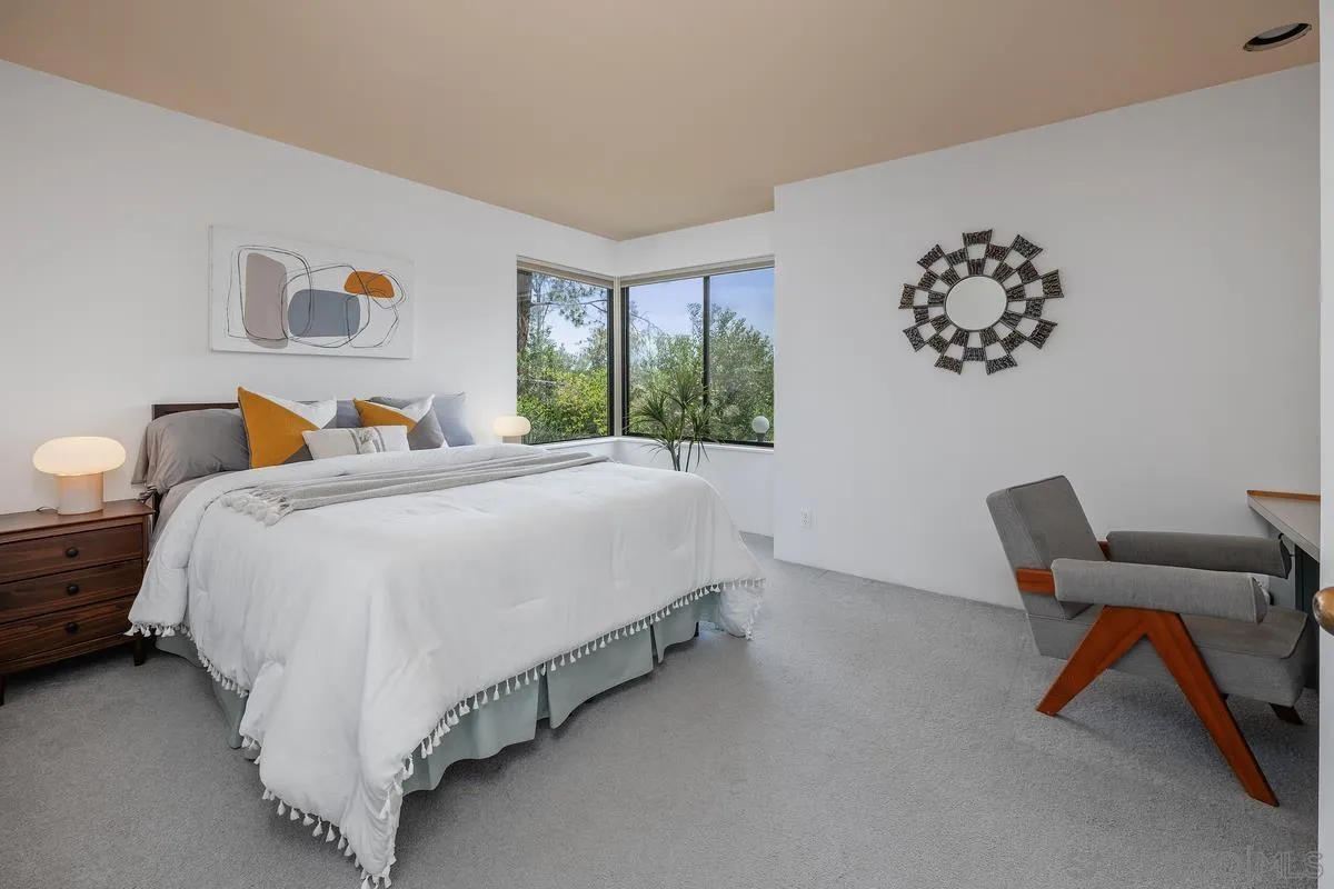 14430 Rancho Santa Fe Farms Road Rancho Santa Fe, CA 92067 - Photo 26 of 51 a bedroom with a bed and a chair