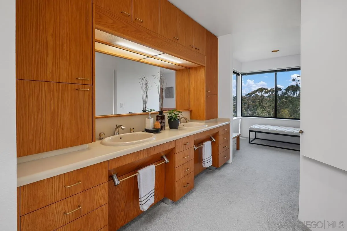 14430 Rancho Santa Fe Farms Road Rancho Santa Fe, CA 92067 - Photo 33 of 51 a bathroom with double vanity and a large mirror