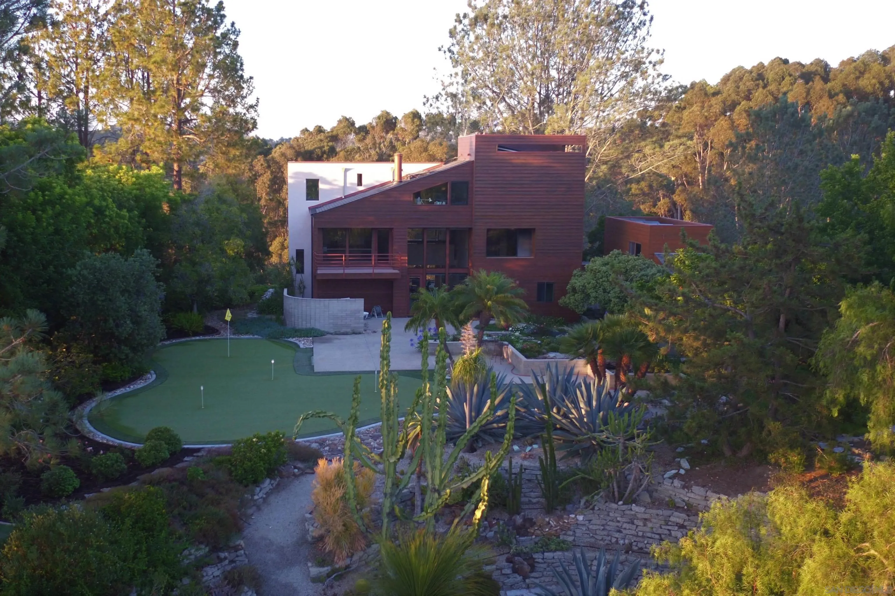 14430 Rancho Santa Fe Farms Road Rancho Santa Fe, CA 92067 - Photo 4 of 51 a view of a house with a yard and a garden