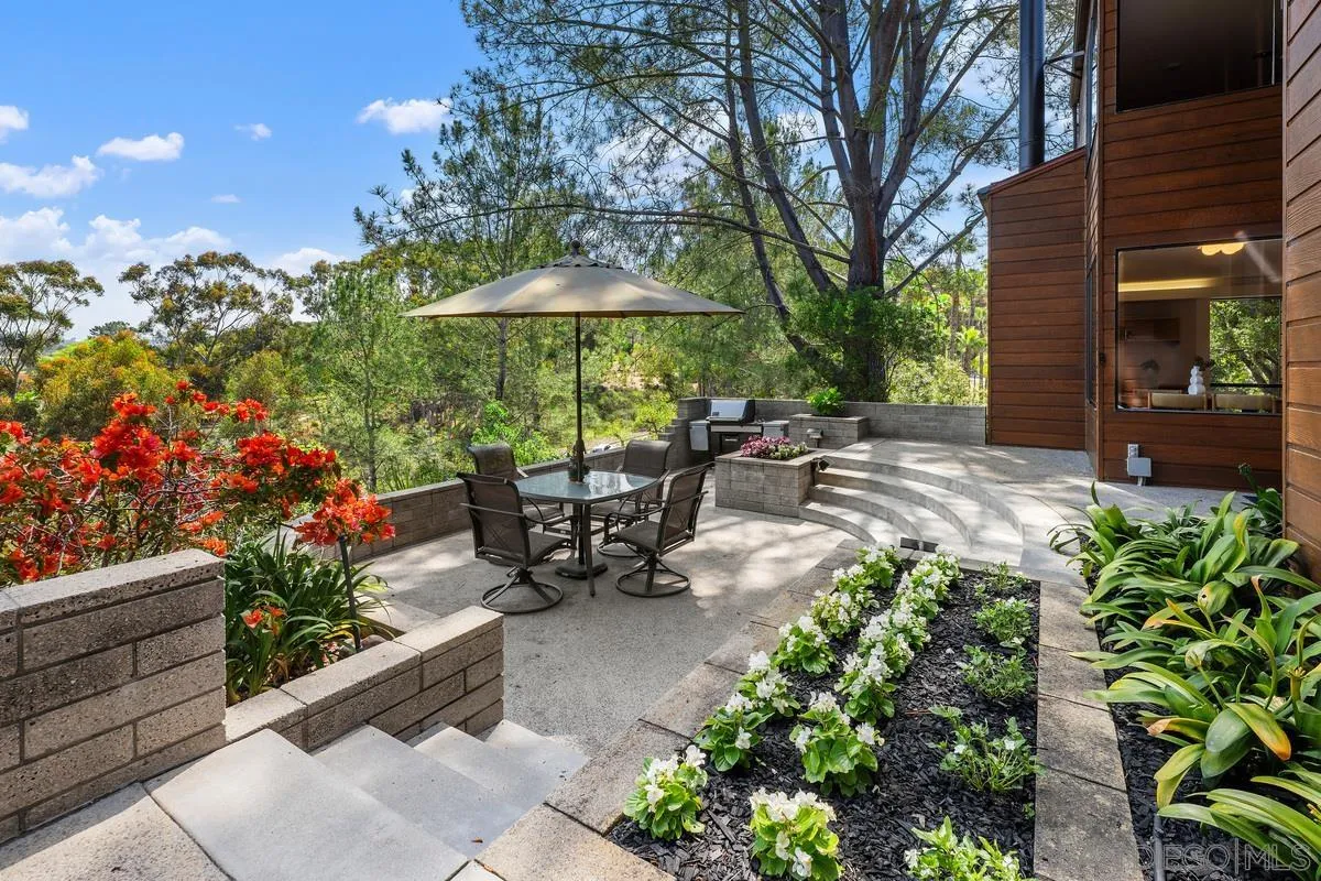 14430 Rancho Santa Fe Farms Road Rancho Santa Fe, CA 92067 - Photo 45 of 51 a view of a chair and table in the patio with a fire pit