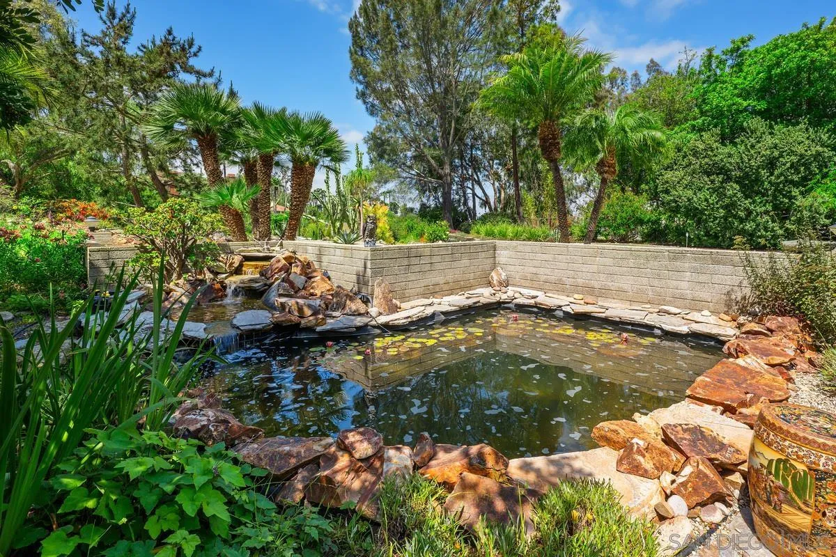 14430 Rancho Santa Fe Farms Road Rancho Santa Fe, CA 92067 - Photo 47 of 51 a backyard of a house with lots of green space