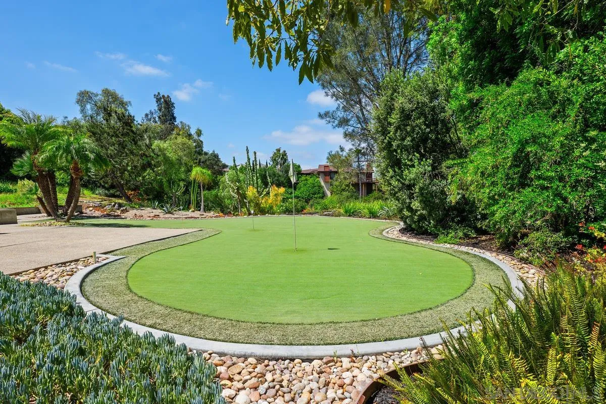 14430 Rancho Santa Fe Farms Road Rancho Santa Fe, CA 92067 - Photo 48 of 51 a view of a swimming pool with a yard