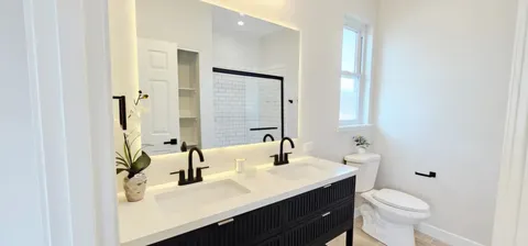 a bathroom with a sink toilet and mirror