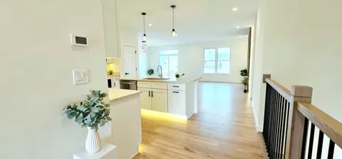 a large white kitchen with cabinets