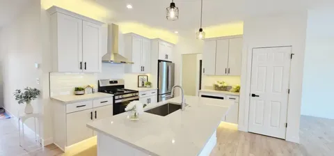 a kitchen with a sink a refrigerator and a stove