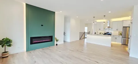 a view of kitchen with stainless steel appliances kitchen island refrigerator stove and cabinets