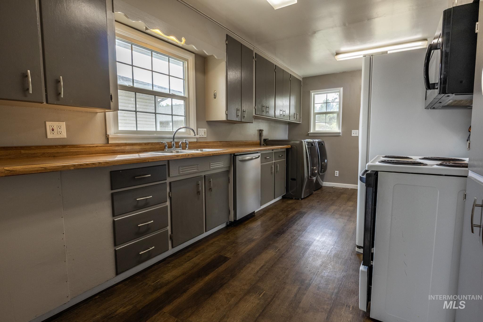 3228 5th Street Lewiston, ID 83501 - Photo 13 of 24 Kitchen featuring black appliances, dark wood-type flooring, wooden counters, and gray cabinets
