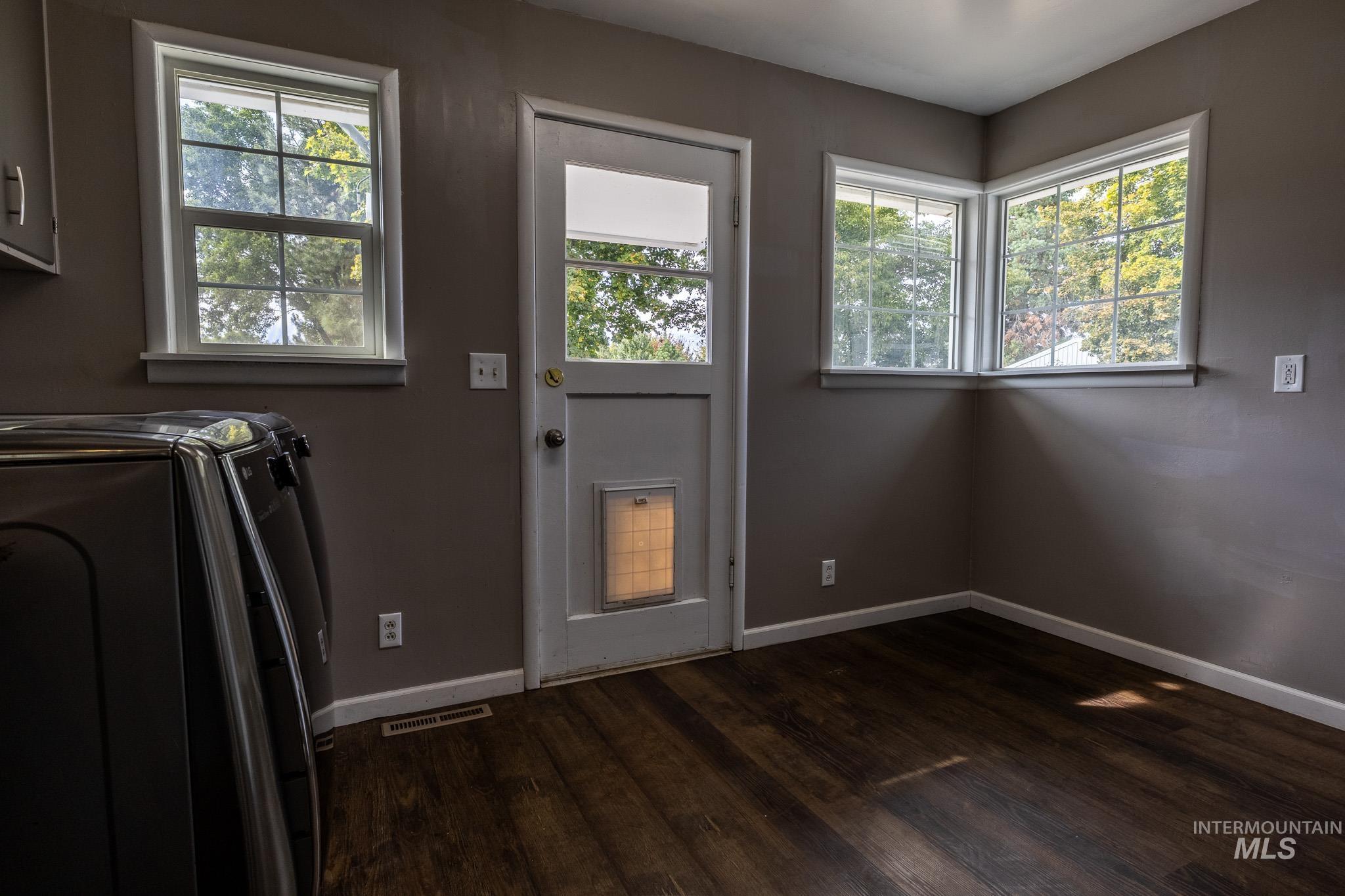 3228 5th Street Lewiston, ID 83501 - Photo 16 of 24 Washroom with dark wood-type flooring and washer and clothes dryer