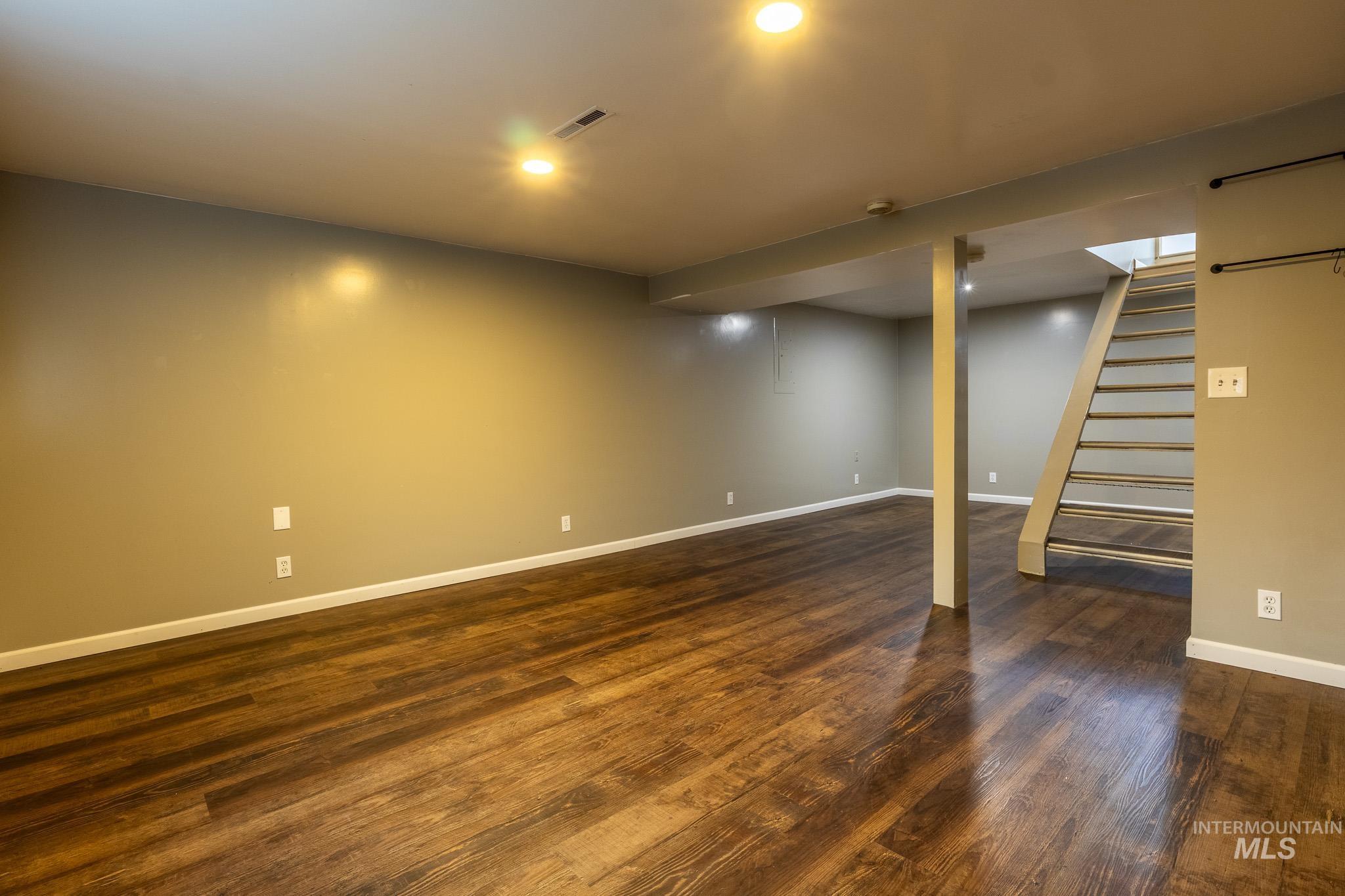 3228 5th Street Lewiston, ID 83501 - Photo 18 of 24 Finished basement featuring stairway, dark wood-style floors, and recessed lighting