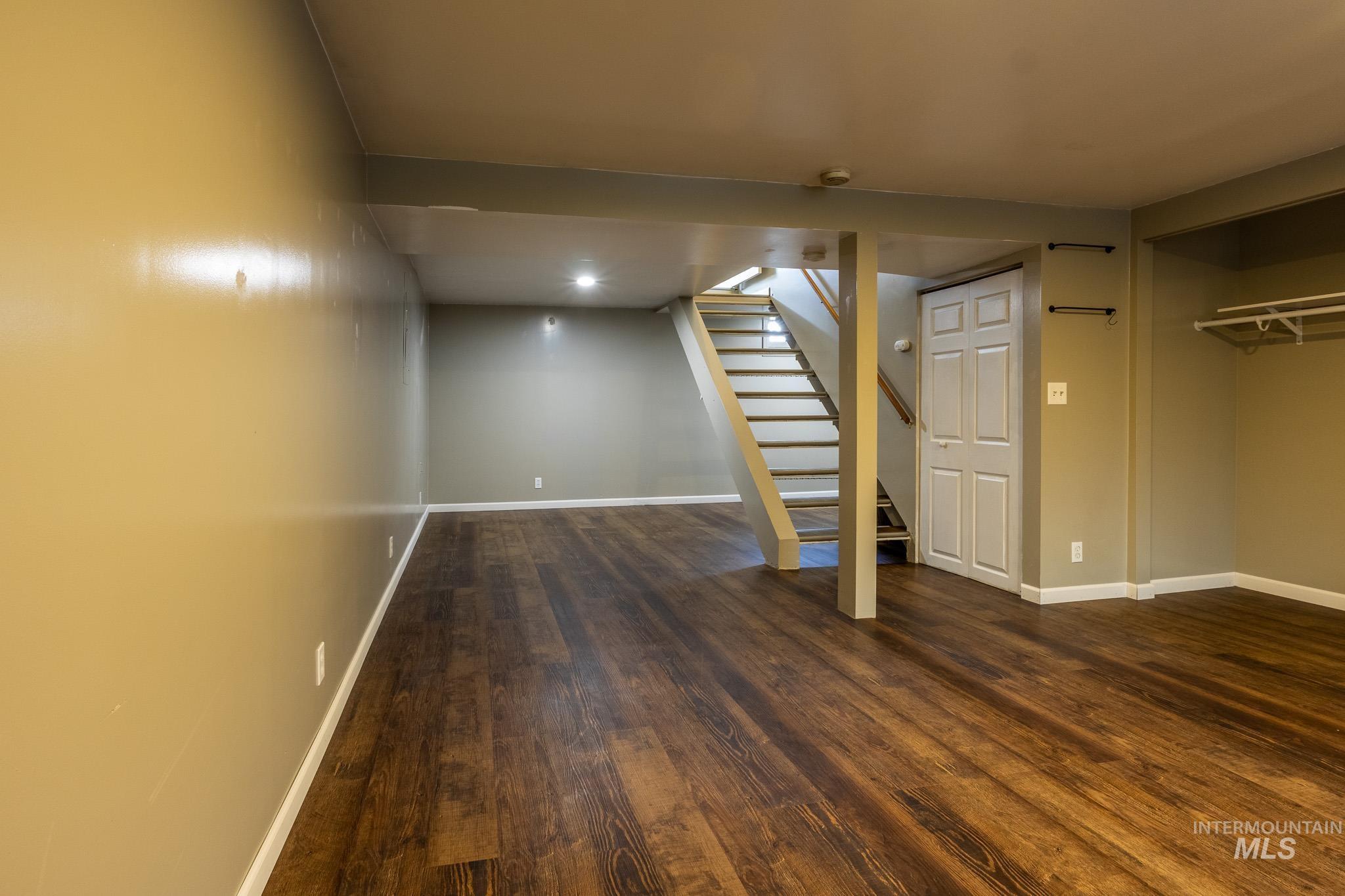 3228 5th Street Lewiston, ID 83501 - Photo 19 of 24 Finished basement with stairway and dark wood-style floors