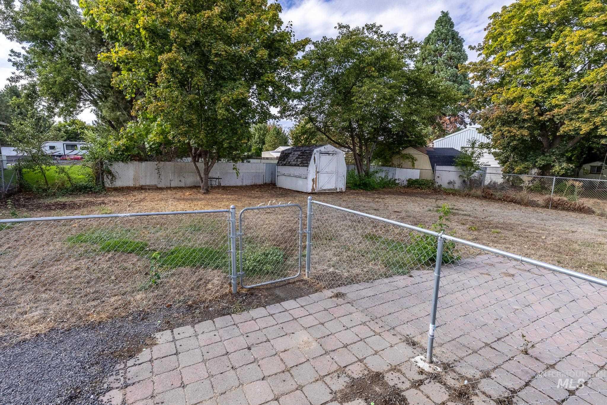 3228 5th Street Lewiston, ID 83501 - Photo 21 of 24 Fenced backyard featuring a storage shed and a gate