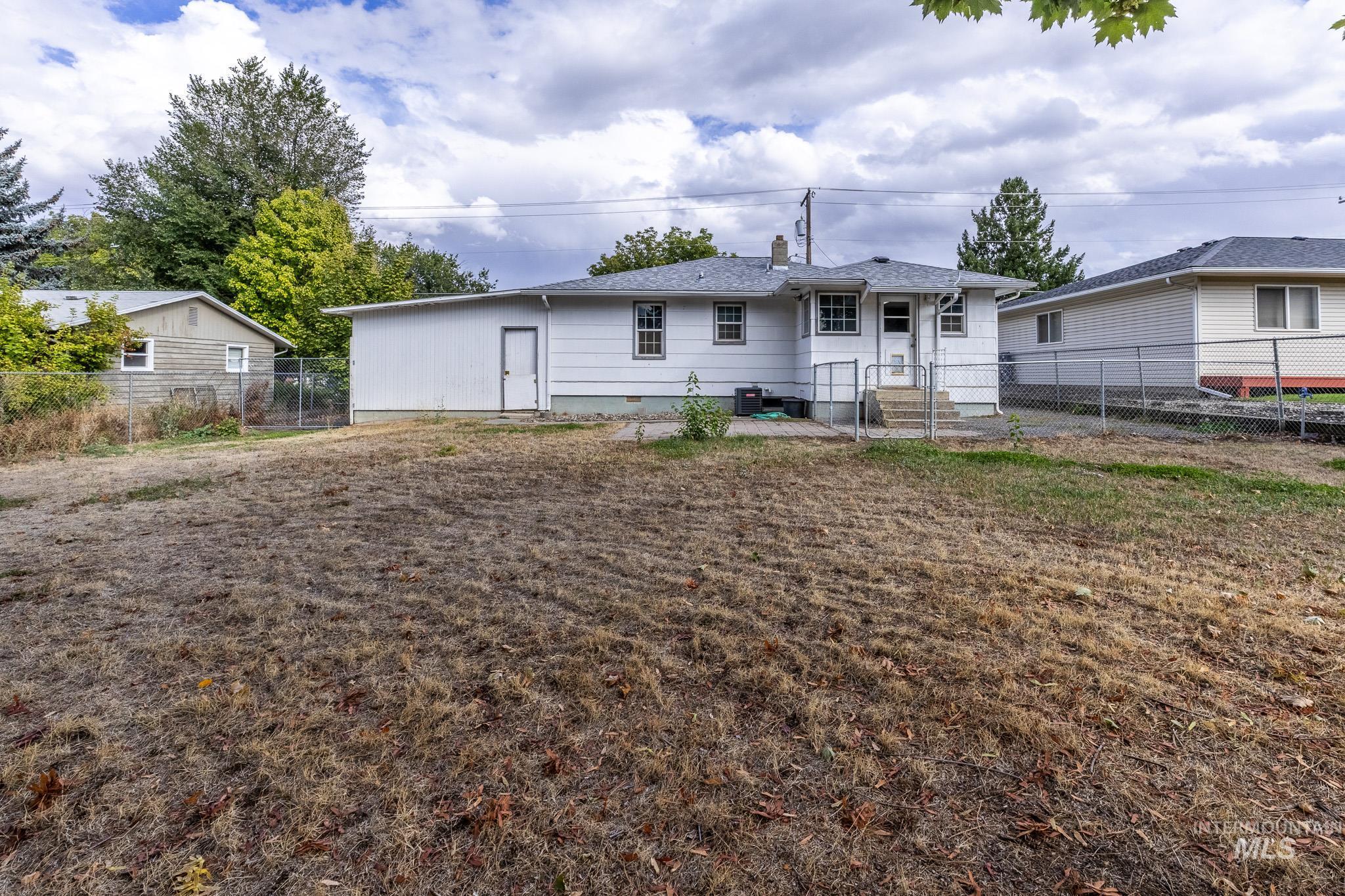 3228 5th Street Lewiston, ID 83501 - Photo 23 of 24 Back of house featuring a fenced backyard and a chimney