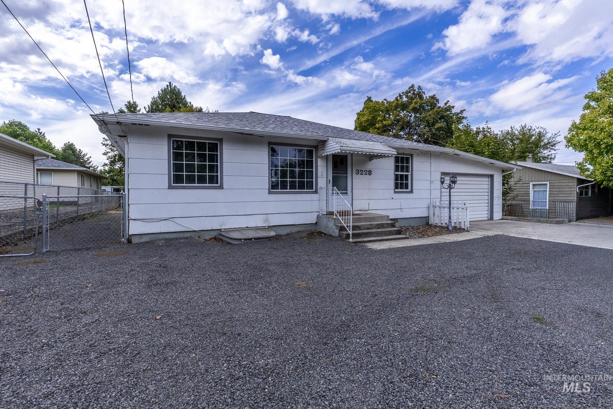 3228 5th Street Lewiston, ID 83501 - Photo 3 of 24 View of front facade featuring driveway, roof with shingles, and a garage