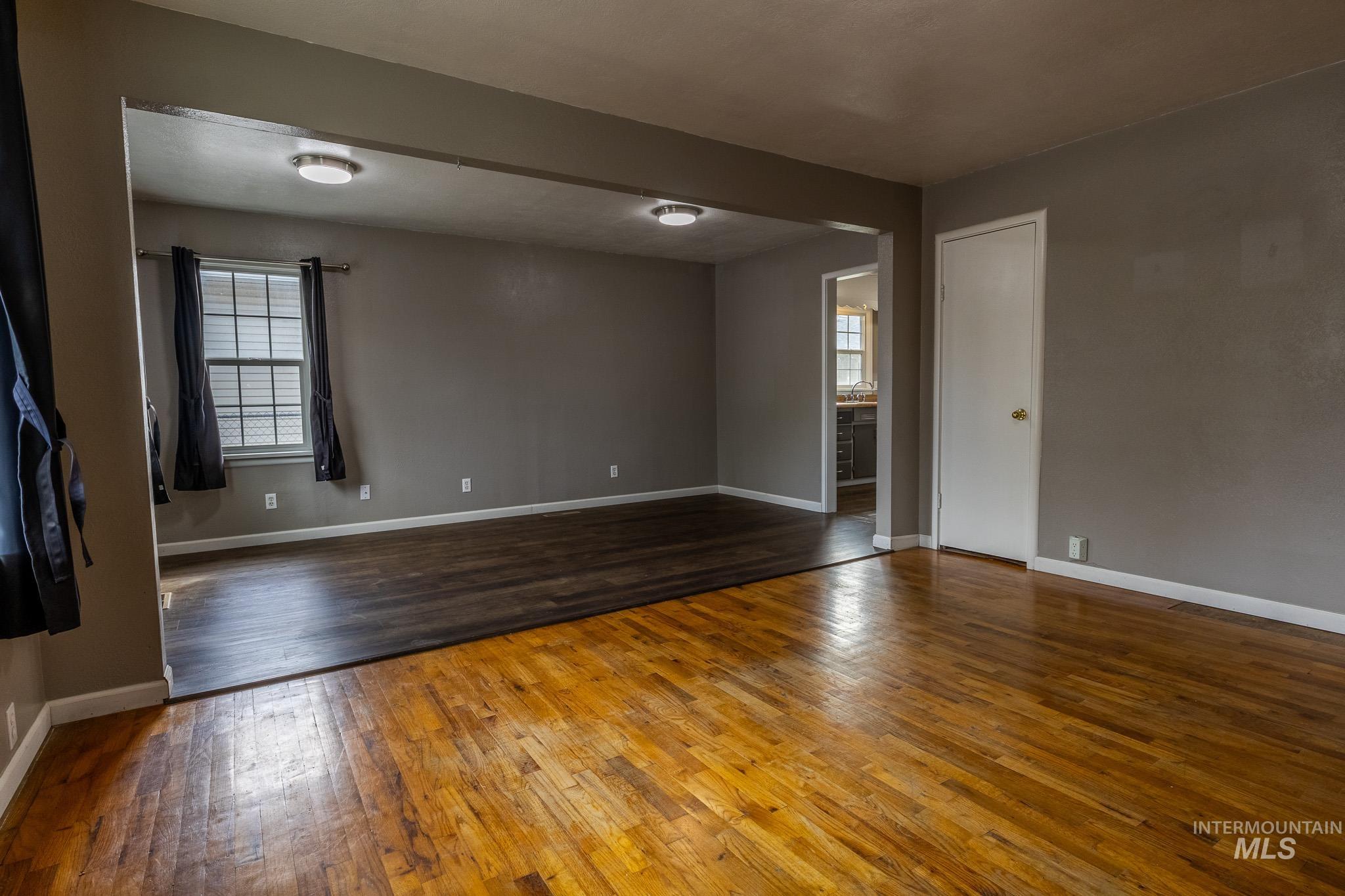 3228 5th Street Lewiston, ID 83501 - Photo 5 of 24 Empty room with dark wood finished floors and baseboards