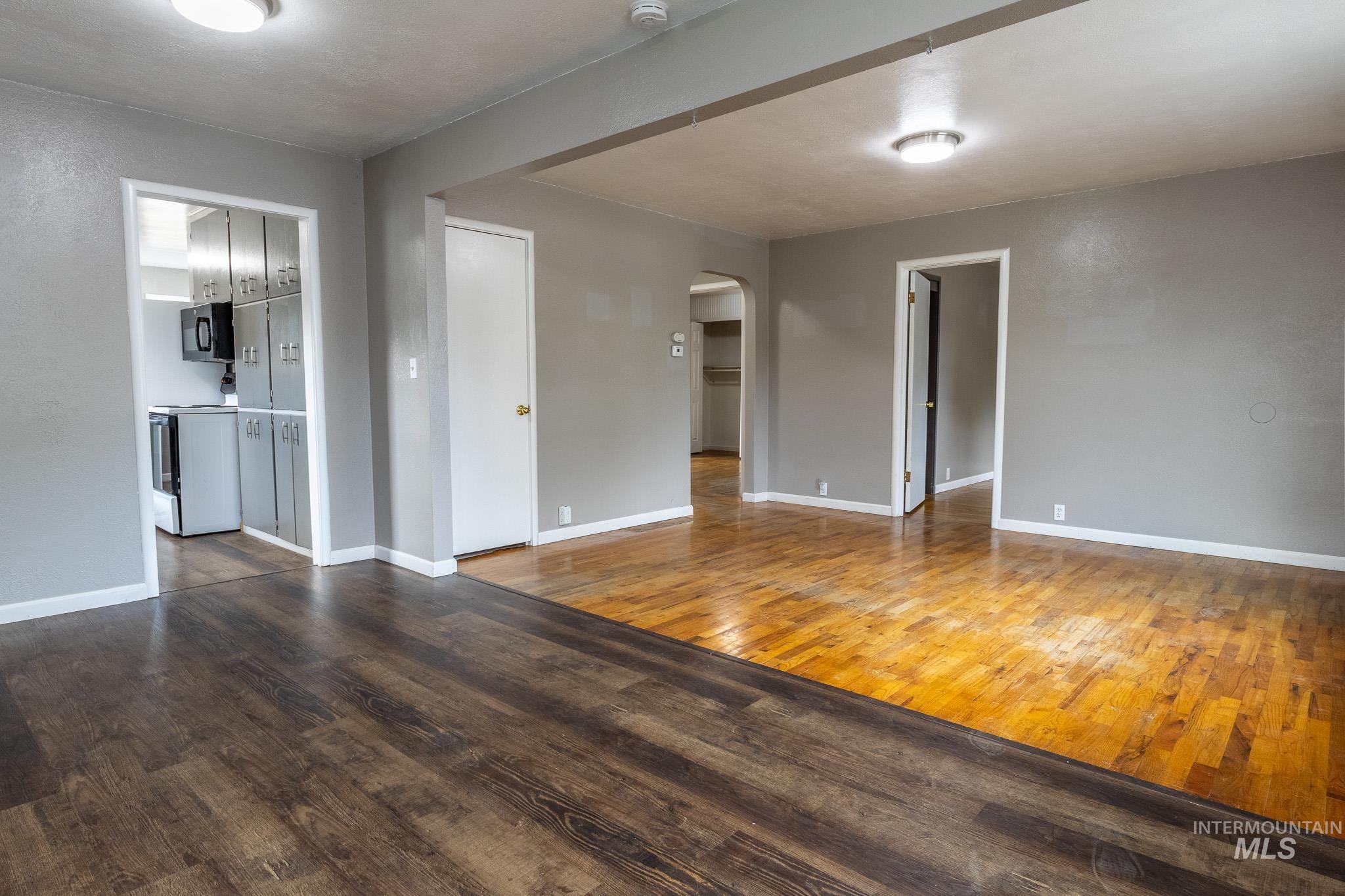 3228 5th Street Lewiston, ID 83501 - Photo 6 of 24 Unfurnished living room with wood-type flooring and arched walkways