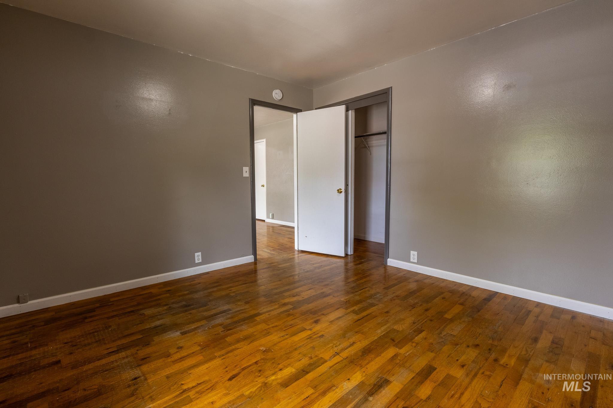 3228 5th Street Lewiston, ID 83501 - Photo 7 of 24 Unfurnished bedroom featuring dark wood-type flooring and a closet