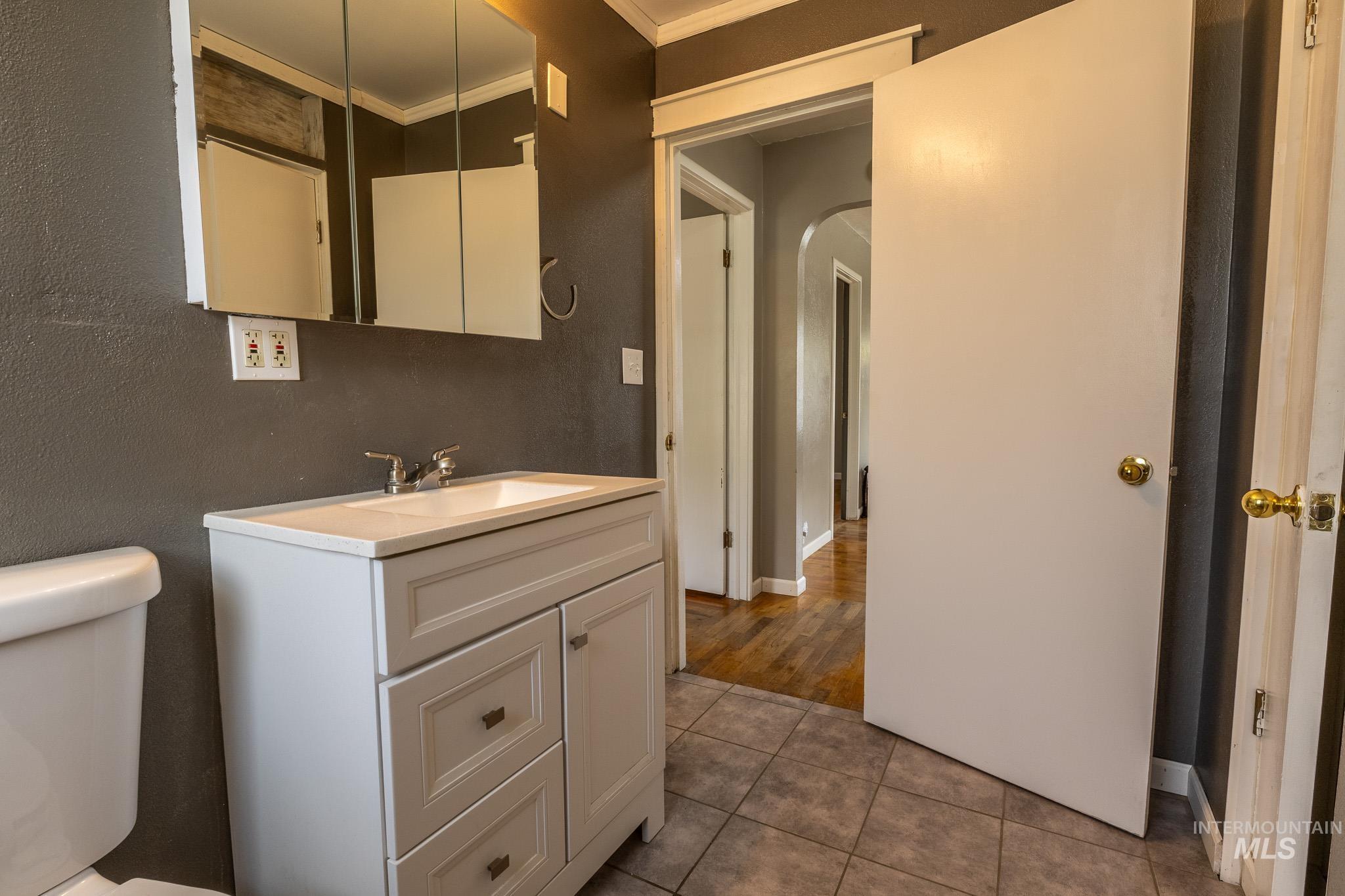 3228 5th Street Lewiston, ID 83501 - Photo 9 of 24 Bathroom featuring ornamental molding, vanity, and light tile patterned floors