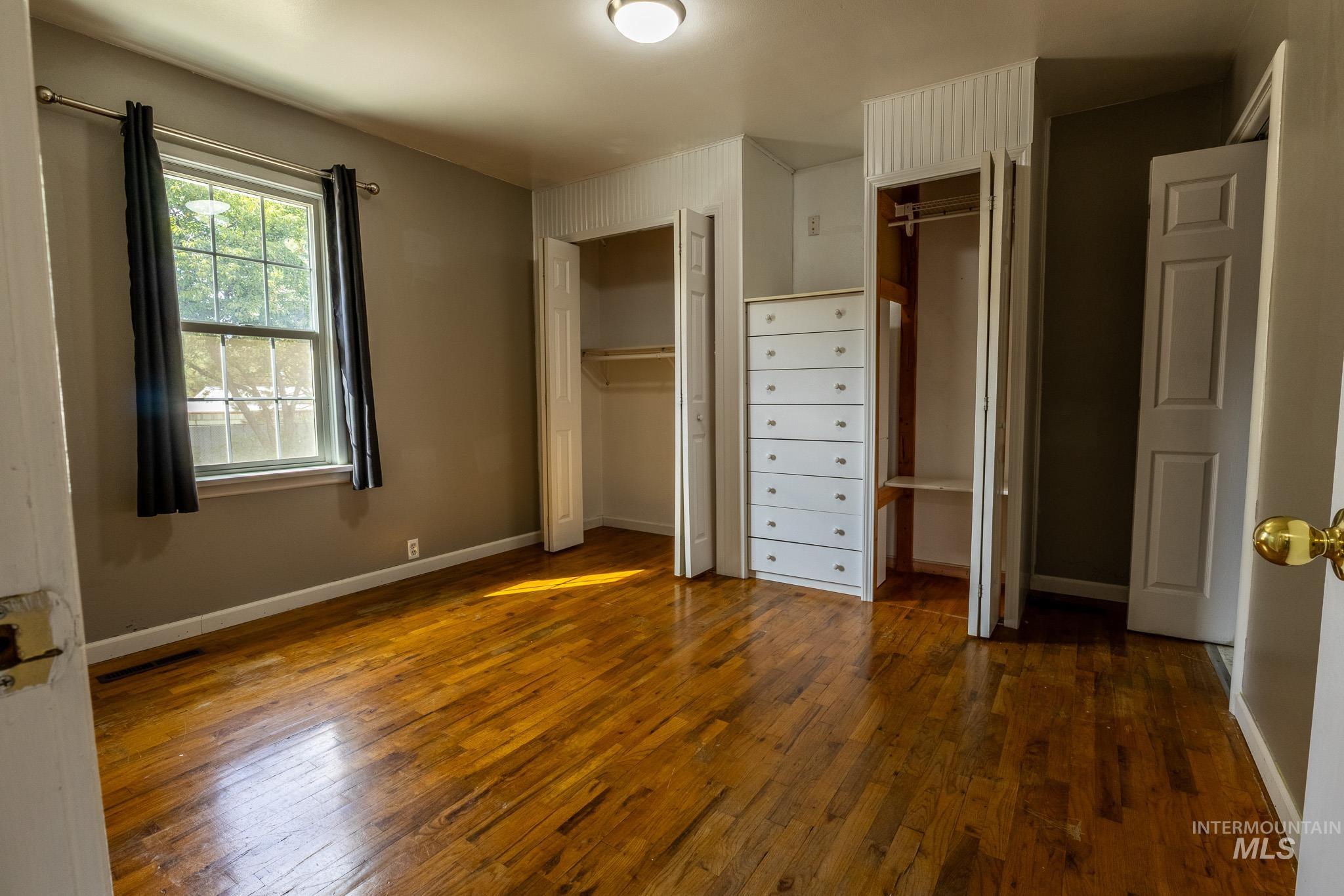 3228 5th Street Lewiston, ID 83501 - Photo 10 of 24 Unfurnished bedroom featuring multiple closets and dark wood finished floors