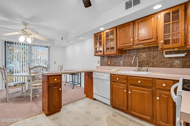 a kitchen with stainless steel appliances granite countertop a sink dishwasher stove and cabinets