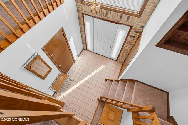 a view of front door with wooden floor and stairs