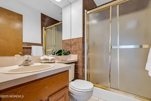 a bedroom with a bed a chair and a large window