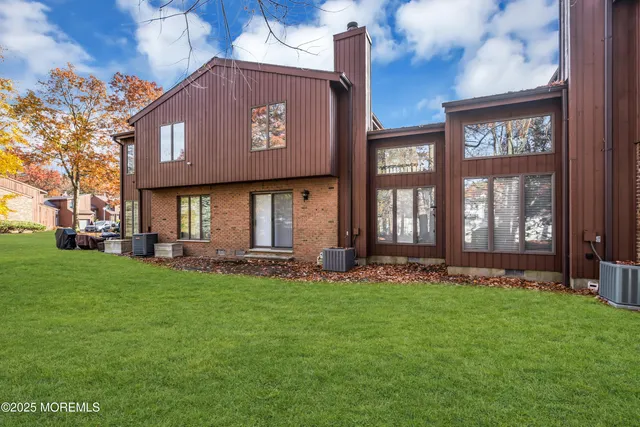 a view of a house with a yard and pathway