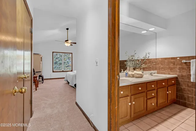 a spacious bedroom with a bed and a chandelier