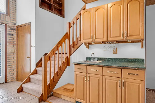 a view of an entryway with wooden floor and staircase