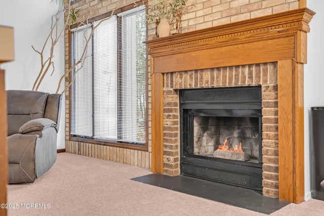 a bedroom with a fireplace and a window